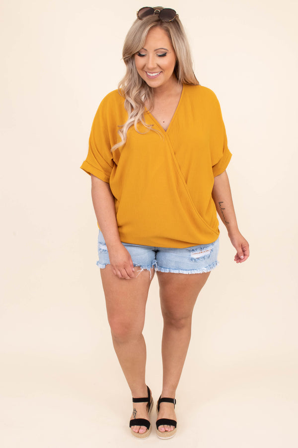 Plus Size light wash denim shorts with distressing and frayed hems.