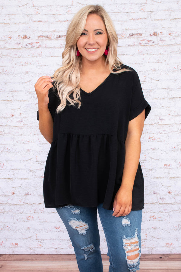Plus Size black babydoll top with a v-neckline, cuffed short sleeves, and a flowy tiered hem.