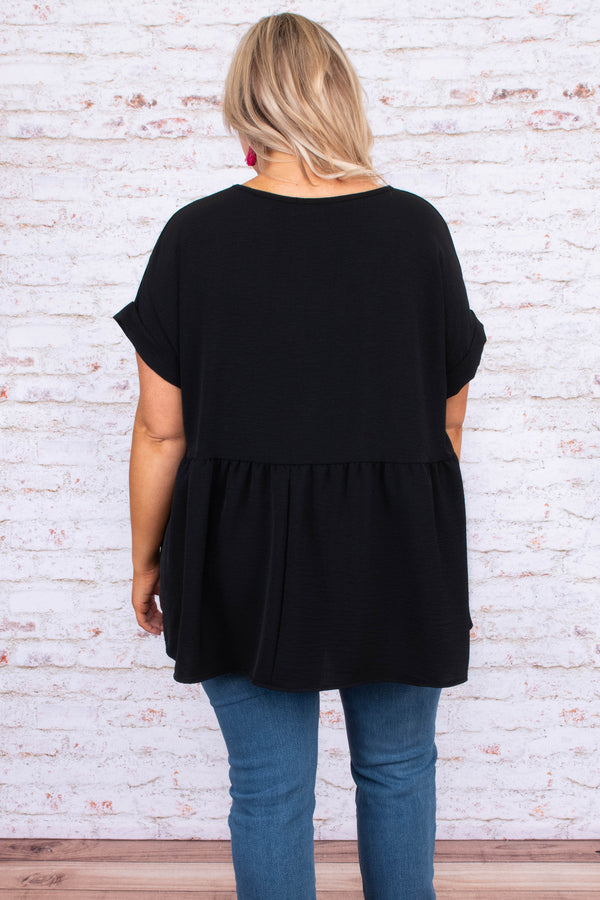 Plus Size black babydoll top with a v-neckline, cuffed short sleeves, and a flowy tiered hem.
