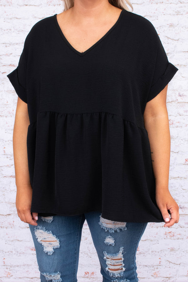 Plus Size black babydoll top with a v-neckline, cuffed short sleeves, and a flowy tiered hem.