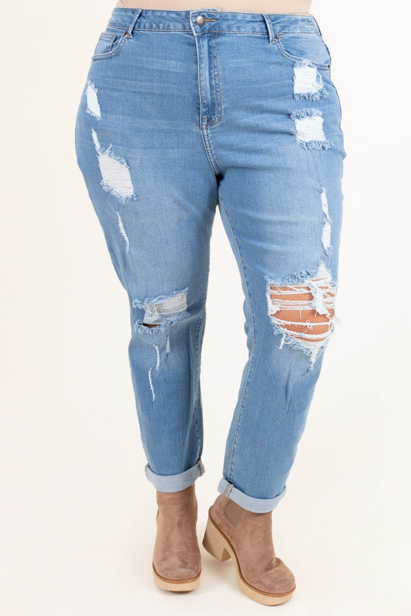 Plus Size light blue distressed jeans with a stretchy fit and cuffed hems.