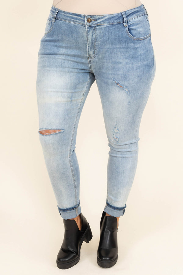 Chic Soul plus size clothing, mid-waisted light-wash denim slim-fitting jeans with light distressed detailing on the legs
