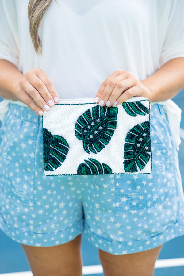 Plus Size white beaded clutch with green tropical leaf patterns and a top zipper closure.